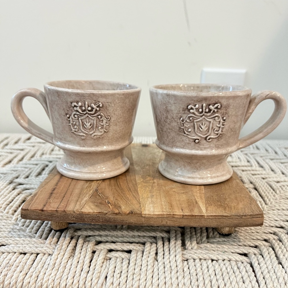 Lot of 2 Italian raised emblem ceramic glazed coffee cups.